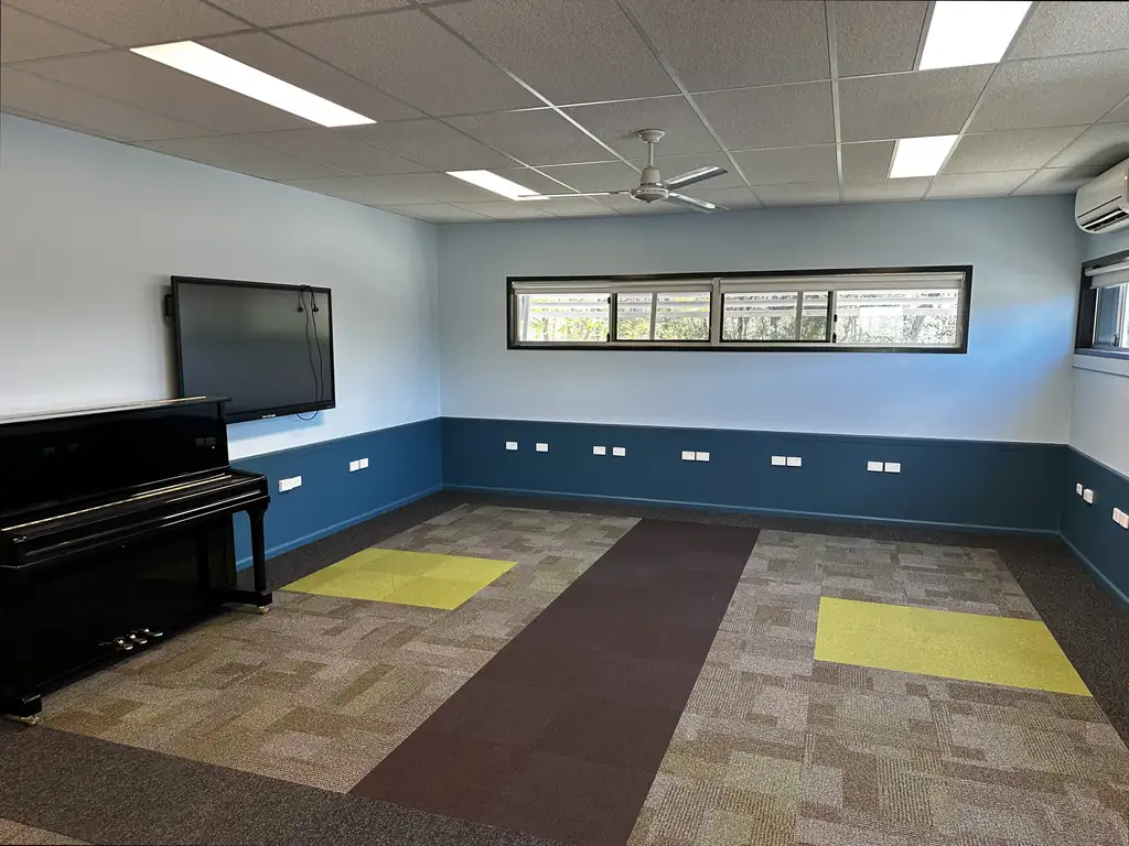 The same music room finished: navy blue lower walls, pale blue upper walls and a fresh white ceiling