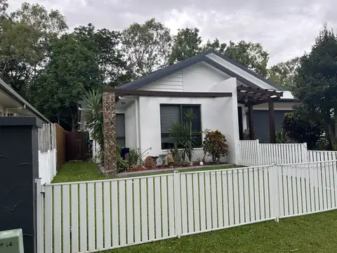 A white house and picket fence after an exterior repaint