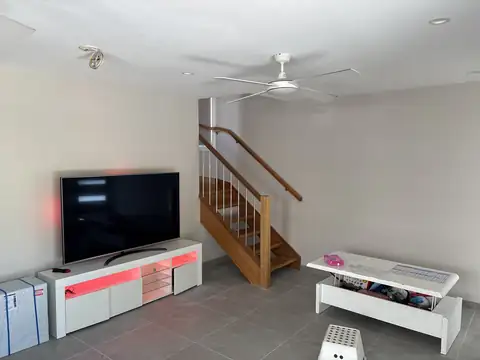 A bright white living room and staircase after an interior repaint